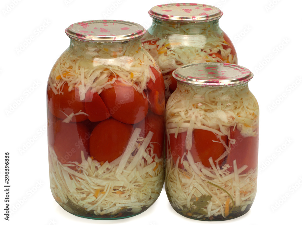 Canned and preserved tomatoes and cabbage in glass jar. Homemade pickled vegetables. Canned and preserved tomatoes and cabbage in glass jar. Homemade pickled vegetables.