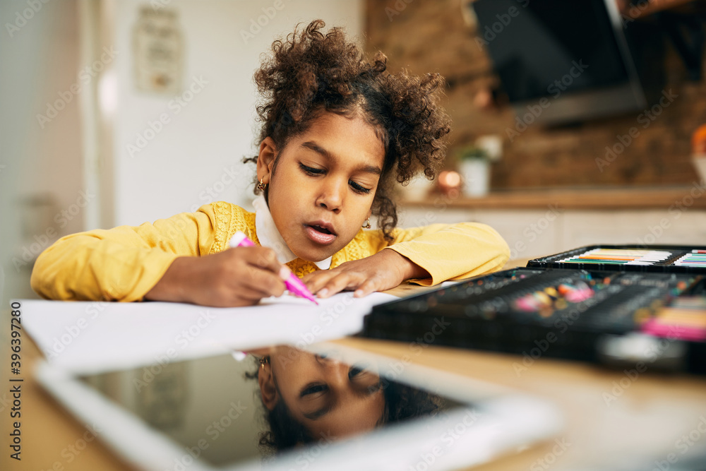 Cute black girl drawing on the paper at home. Cute black girl drawing on the paper at home.