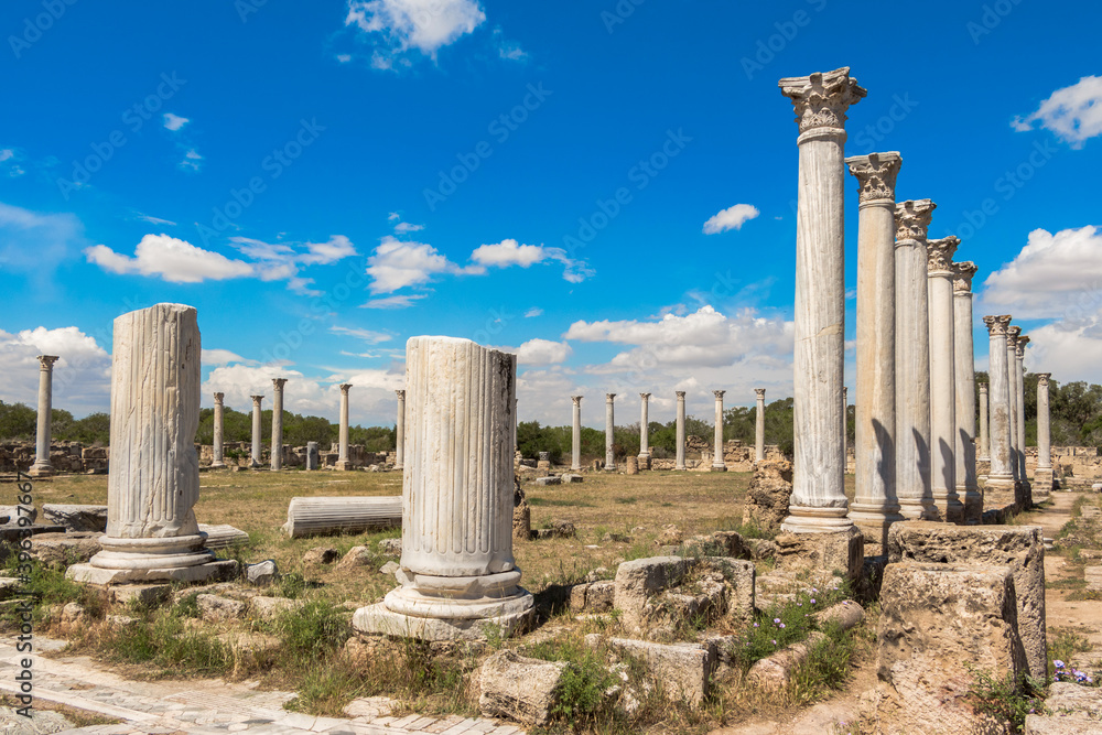 Ruins of the ancient greek city of Salamis. Medieval columns and stones, historical architecture, tourist place, Cyprus, Famagusta. Clear blue sky with white clouds.
