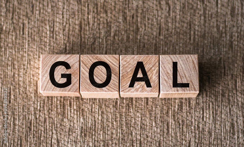 Fototapeta premium GOAL. Word written on wooden blocks over brown background.