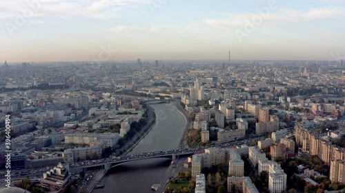 Wallpaper Mural Drone shot of city from above, big river and many buildings at the riversides. Drone fly over zoom out of cityscape in a big city under grey foggy sky Torontodigital.ca