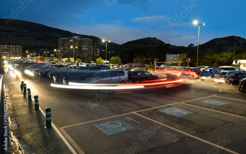 Movement of cars in a parking lot at dusk