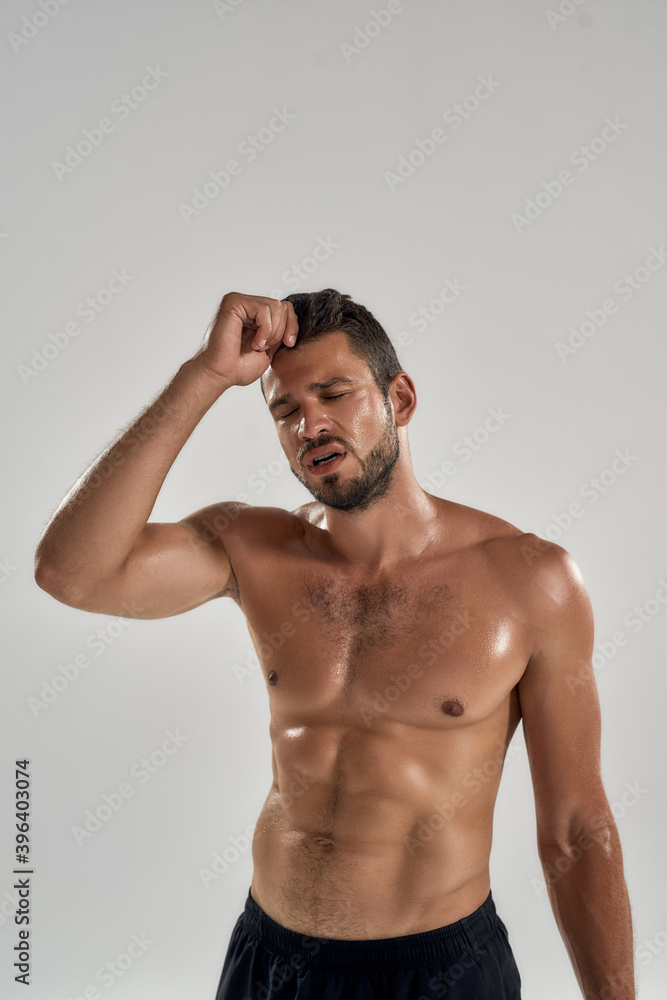 Fototapeta premium Young exhausted caucasian male athlete during training