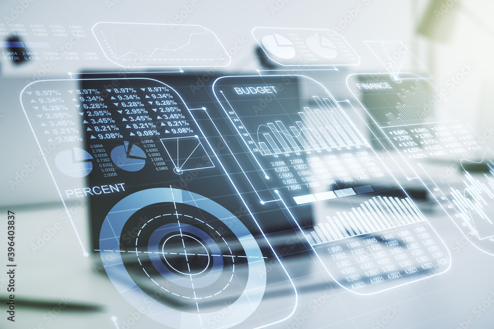Multi exposure of creative statistics data hologram on laptop background, stats and analytics concept Multi exposure of creative statistics data hologram on laptop background, stats and analytics concept