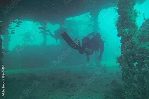 SCUBA Diver swim through wreck