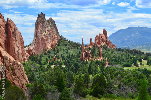 Large red sandstone rocks spires and green trees in the Garden of the Gods park located in Colorado Springs, Colorado, United States 