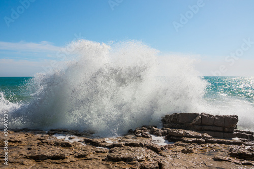 Beautiful waves crashing against the shore. Sunny summer day with a wild ocean. Impressiove and spectacular photography. Perfect desktop background.