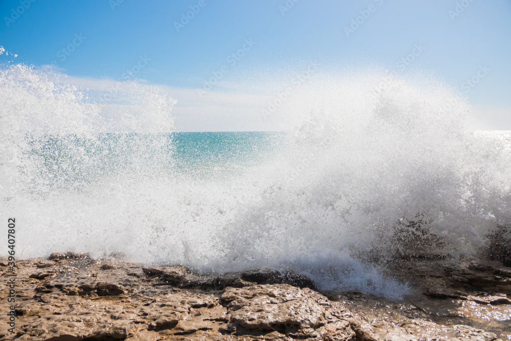 Obraz premium Beautiful waves crashing against the shore. Sunny summer day with a wild ocean. Impressive and spectacular photography. Perfect desktop background.