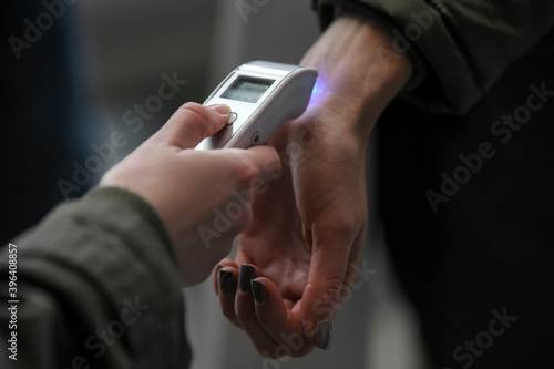 Visitors must go through fever measures using infrared digital thermometer check temperature measurement, fever examination at the building.Measures to prevent people with fever,Corona virus,Covid-19.