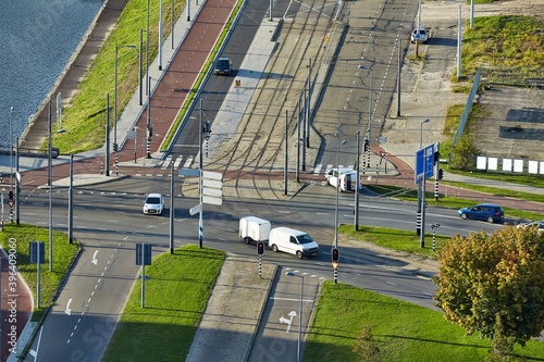 Road intersection with passing cars viewed from above