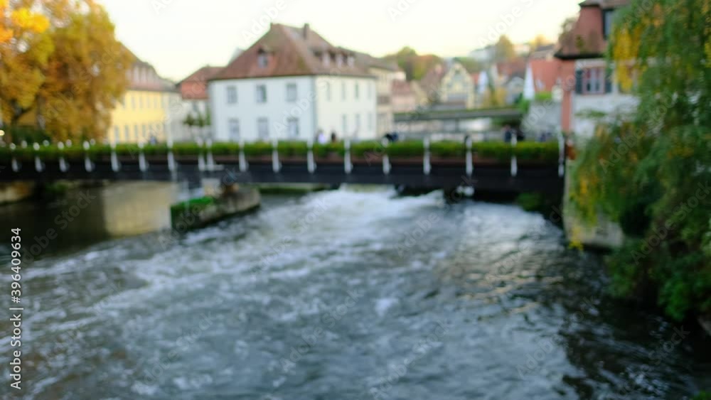 blurred background, a wide river flows among the old houses of the European German city of Bamberg, tourists walk along the stone bridge, concept of travel, tourism blurred background, a wide river flows among the old houses of the European German city of Bamberg, tourists walk along the stone bridge, concept of travel, tourism