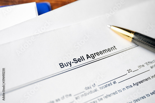 Legal document Buy-Sell Agreement on paper with pen