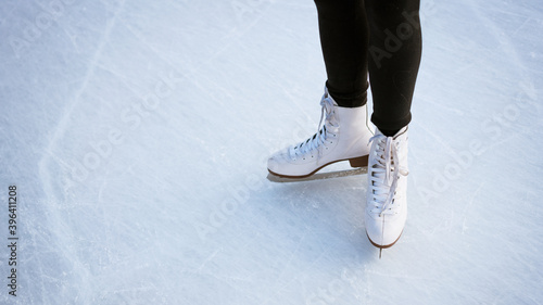 Girl in white skates on ice.
