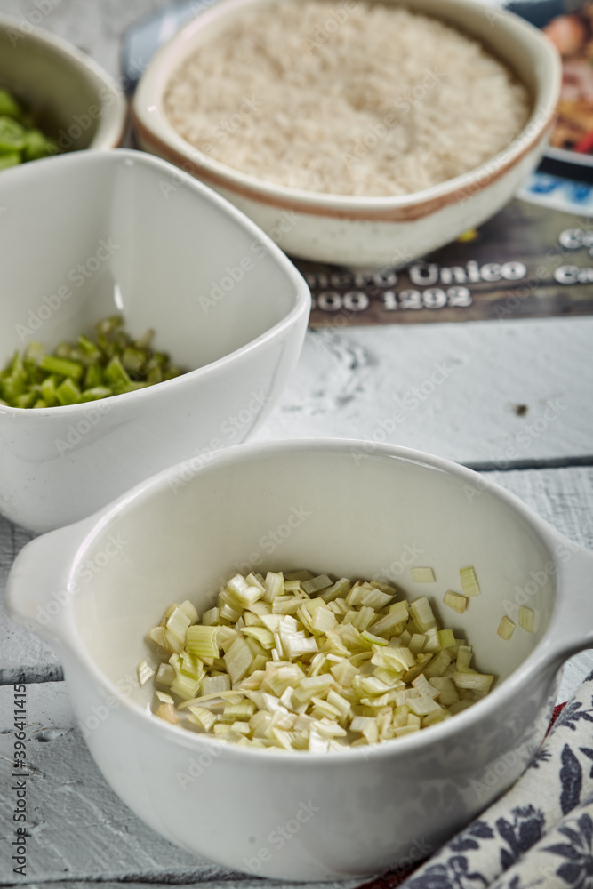 Bowl of chopped onion on wood background Bowl of chopped onion on wood background