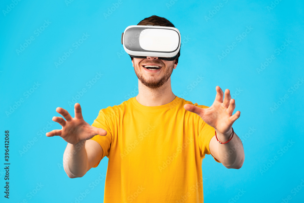Smiling man wearing virtual reality headset at the studio Smiling man wearing virtual reality headset at the studio
