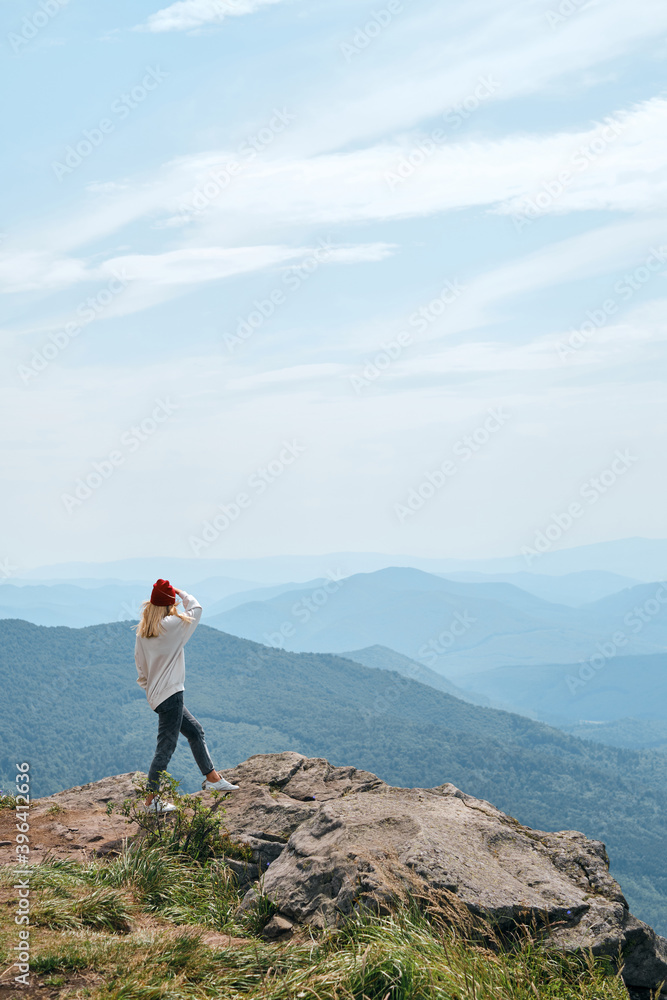 Obraz premium Girl enjoy scenics view on valley. Beautiful nature landscape in mountains. Hiking journey on tourist trail. Outdoor adventure. Travel and exploration. Healthy lifestyle, leisure activities