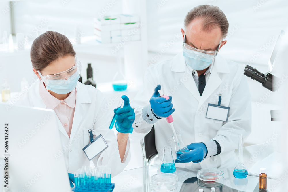 close up. researchers work with tests in the laboratory. close up. researchers work with tests in the laboratory.