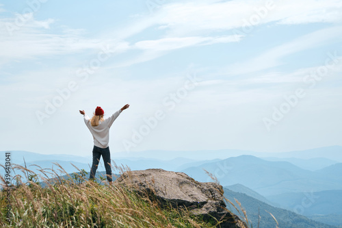 Girl enjoy scenics view on valley. Beautiful nature landscape in mountains. Hiking journey on tourist trail. Outdoor adventure. Travel and exploration. Healthy lifestyle, leisure activities