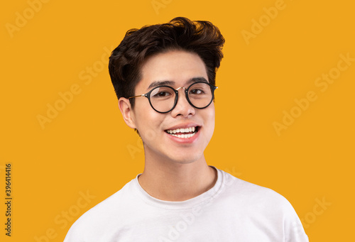 Portrait Of Smiling Young Asian Man Wearing Eyeglasses