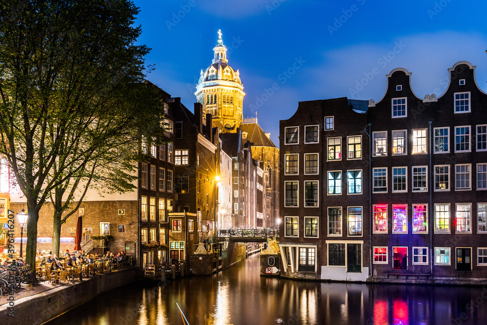 Amsterdam. Night view of Amsterdam cityscape with canal, bridge and typical Dutch Houses.