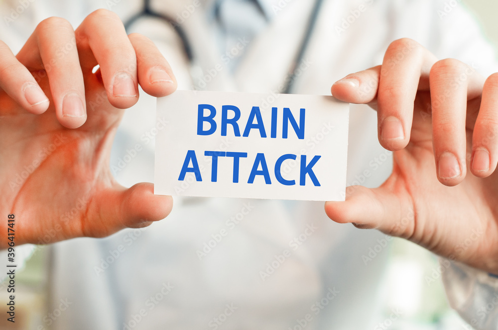 Doctor holding a card with text BRAIN ATTACK, medical concept Doctor holding a card with text BRAIN ATTACK, medical concept