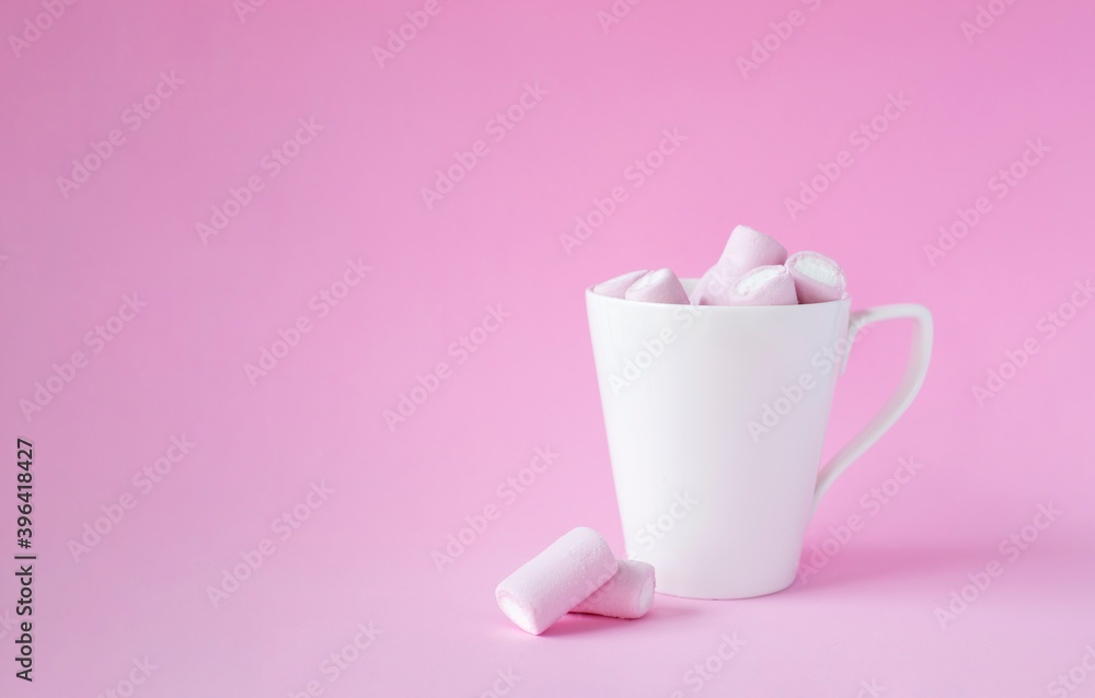 pink marshmallow in white cup on pink background. Christmas, mother's day, birthday card concept pink marshmallow in white cup on pink background. Christmas, mother's day, birthday card concept
