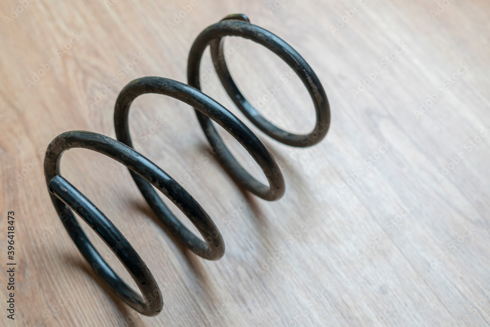 close up black car suspension spring isolated close up black car suspension spring isolated