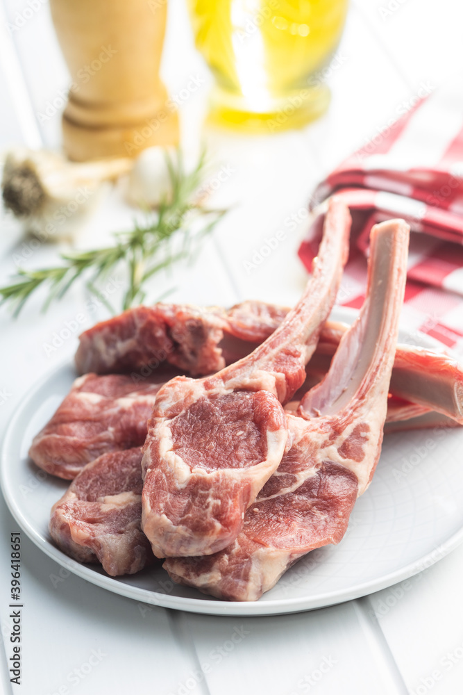 Slices raw lamb chops on plate