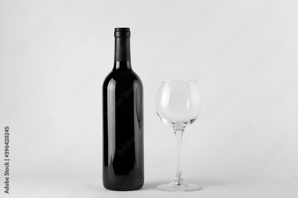 Black wine bottle with red wine isolated on white Black wine bottle with red wine isolated on white
