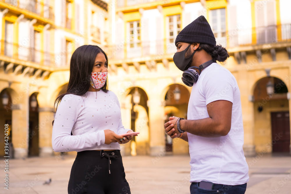 Lifestyle, black Latino friends talking at a meeting with face masks. Friendships in the coronavirus pandemic, covid-19. Social distance, new normal