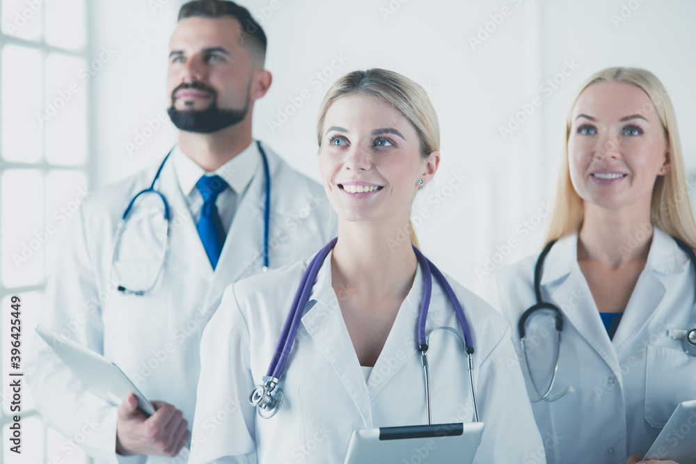 Smiling doctors all standing together as they work Smiling doctors all standing together as they work
