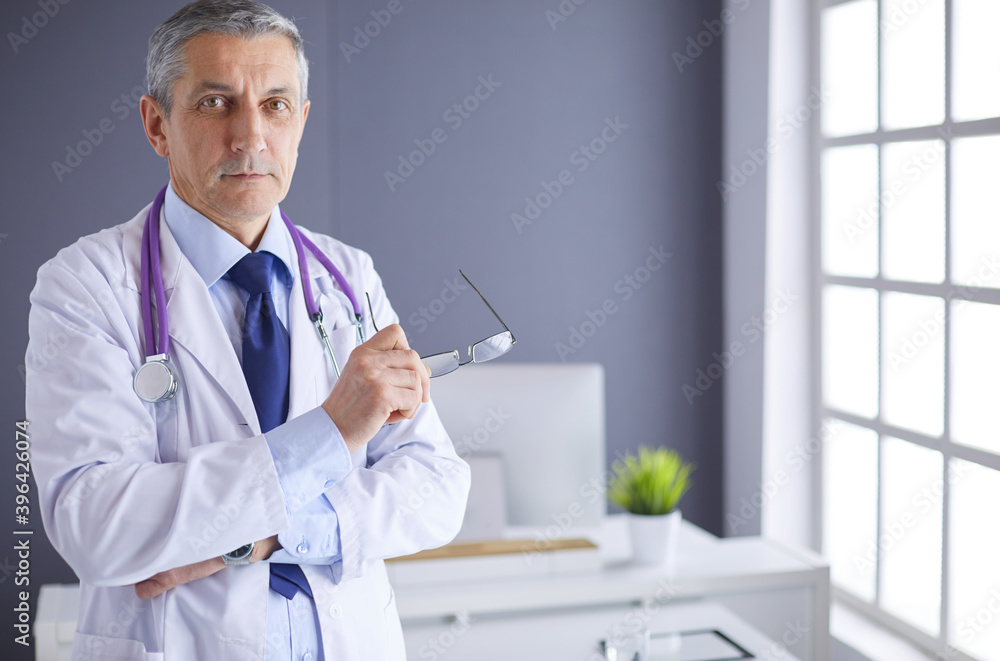 Portrait of a smiling doctor in his bright office Portrait of a smiling doctor in his bright office