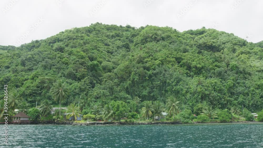 Beautiful view of the tropical mountains in Moorea from the sea, boat, slowmotion shot, French Polynesia Beautiful view of the tropical mountains in Moorea from the sea, boat, slowmotion shot, French Polynesia