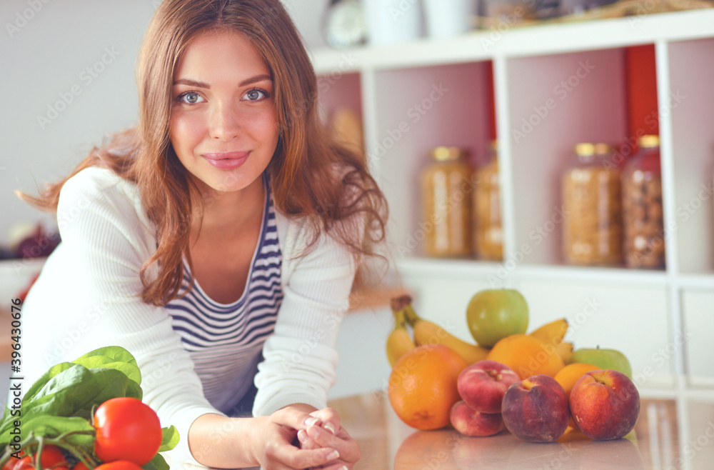 Young woman sitting near desk in the kitchen Young woman sitting near desk in the kitchen