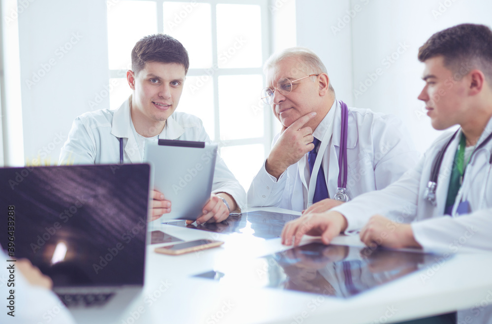 Medical team sitting and discussing at table Medical team sitting and discussing at table