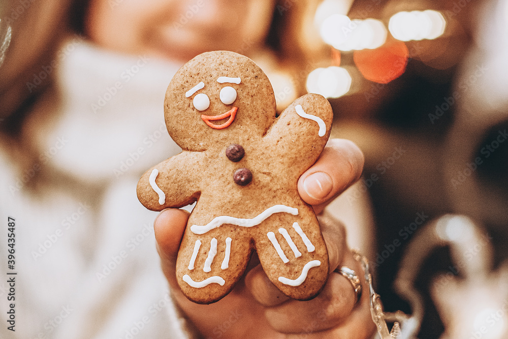 Merry Christmas and Happy New Year! Gingerbread cookie in woman's hands