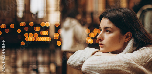 Christian woman prays in church. Hands crossed on wooden table. Christian Background