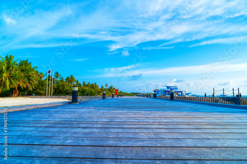 Wooden bridges leading to the huts on the shores of the tropical, warm sea. Maldives. Tourism concept.