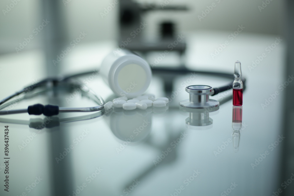 Stethoscope ampoule pill microscope on glass table Stethoscope ampoule pill microscope on glass table