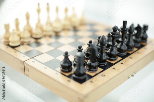 Wood chess pieces on a board