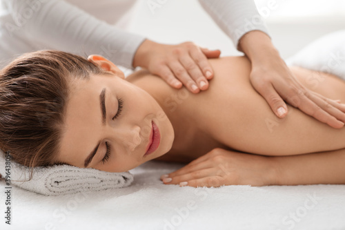Closeup of beautiful woman enjoying back massage