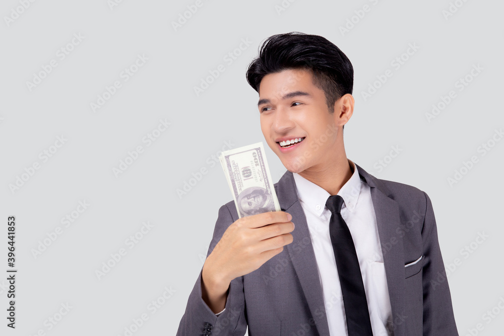 Young asian business man holding money dollar isolated on white background, businessman in suit holding banknote and success and excited with finance, savings and investment, income and spending. Young asian business man holding money dollar isolated on white background, businessman in suit holding banknote and success and excited with finance, savings and investment, income and spending.