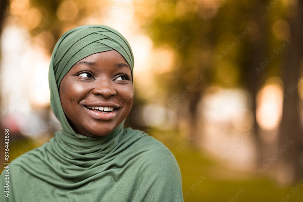 Closeup Portrait Of Beautiful Smiling African Islamic Woman In Hijab Standing Outdoors Closeup Portrait Of Beautiful Smiling African Islamic Woman In Hijab Standing Outdoors