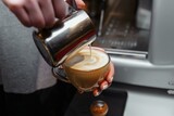 Closeup of barista pouring milk into art cappuccino or latte