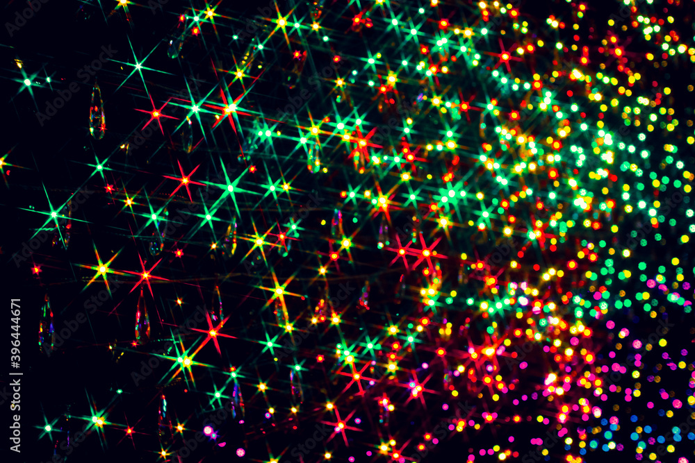 Obraz premium Sparkling LED lights on a black background in green, red and yellow