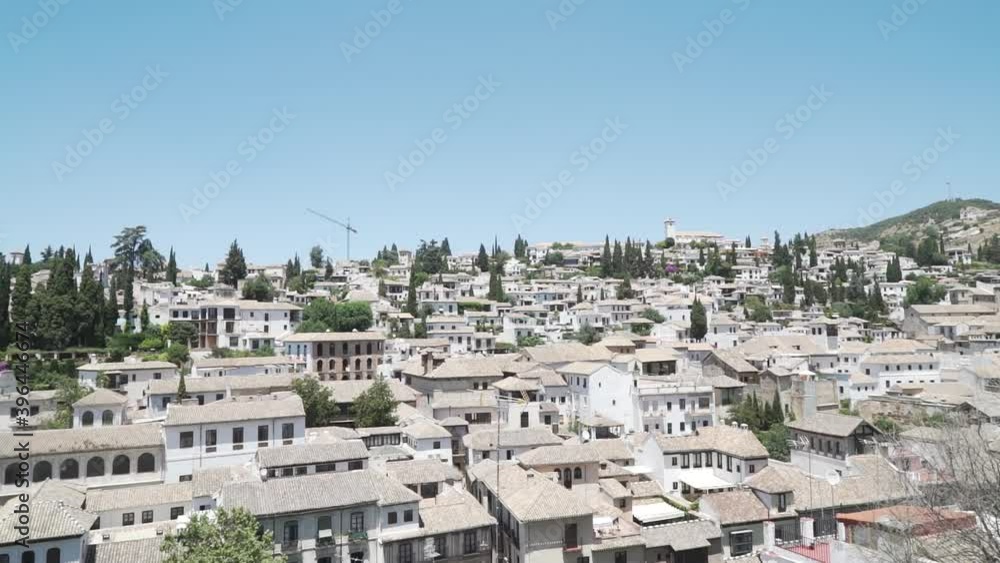 Dense houses with tile roofs in the historical district Albaicin in Granada, Spain. Panning Dense houses with tile roofs in the historical district Albaicin in Granada, Spain. Panning