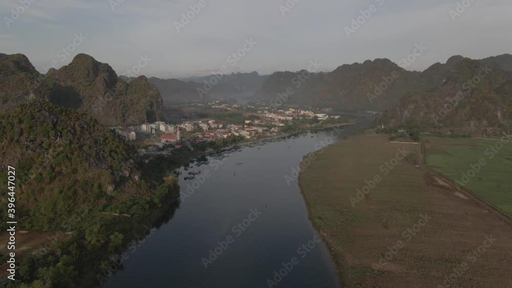 Drone shot moving foward river between mountain in Phong Nha Drone shot moving foward river between mountain in Phong Nha