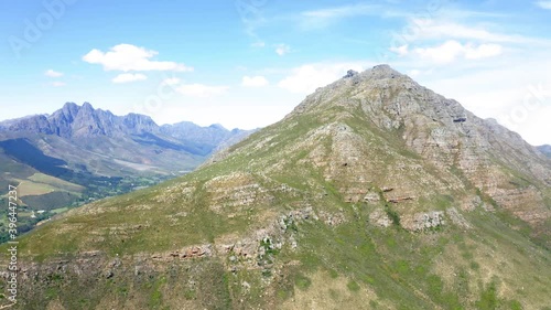 Aerial drone close-up of mountain and peak, blue mountain range and farm land background  summer, Stellenbosch, Hottentots-Holland, Jonkershoek photo