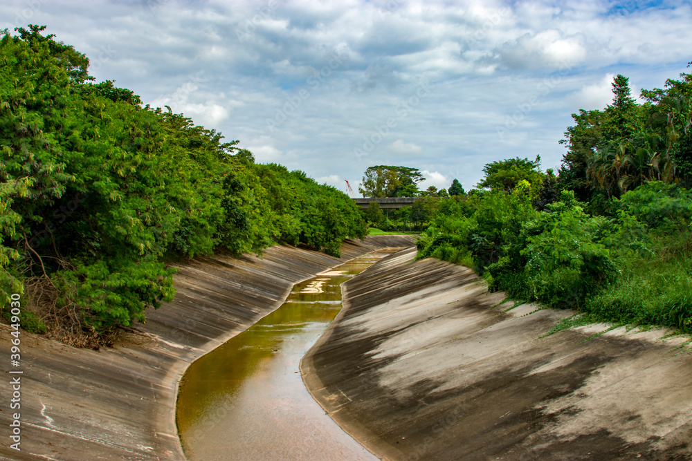 the view of drainage Canal nearby the SengKang riverside park in Singapore. The drainage canal is important for water collection and flooding control in city. the view of drainage Canal nearby the SengKang riverside park in Singapore. The drainage canal is important for water collection and flooding control in city.