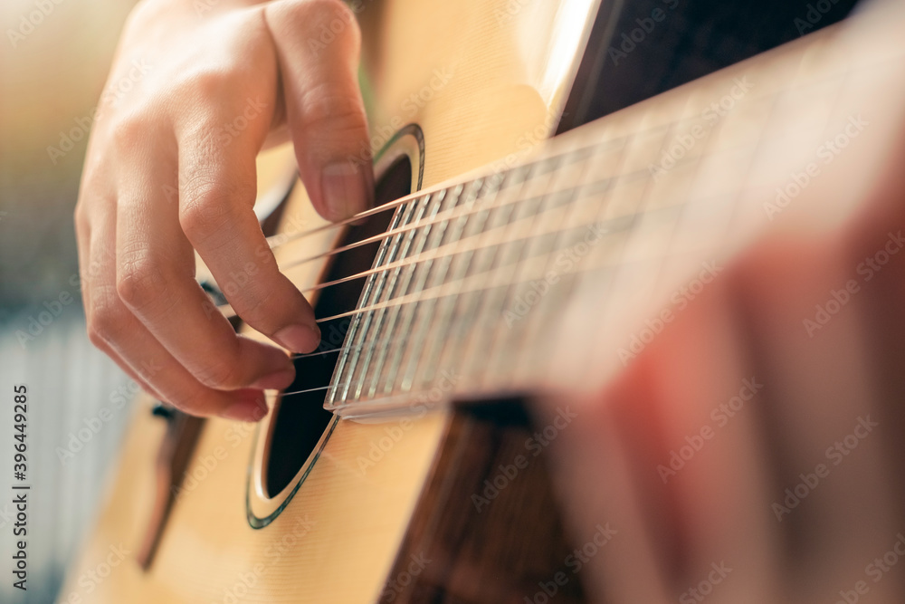 Fototapeta premium Close up of man hand playing guitar.